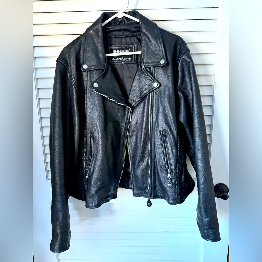 NWOT women’s black genuine leather jacket, size medium, with zip-out liner.
